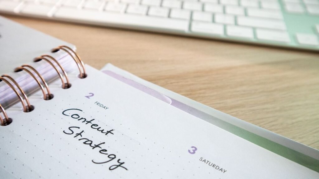 Content strategy written in a planner next to a keyboard