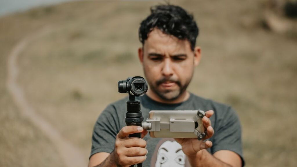 Videographer filming with a smartphone gimbal
